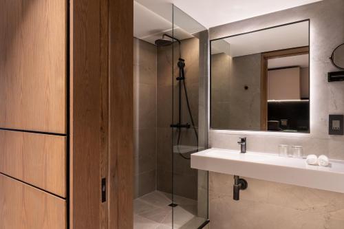 a bathroom with a sink and a mirror at Radisson Hotel Cape Town Foreshore in Cape Town