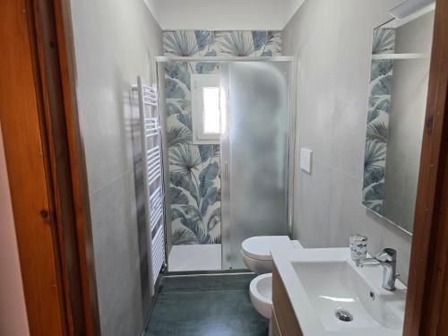 a bathroom with a shower and a toilet and a sink at Attico vista mare in centro in Gallipoli