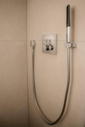 a shower in a bathroom with a shower head at EmsQuartier in Norderney