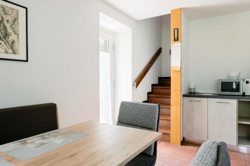 a kitchen and dining room with a table and chairs at Ciasa Silvano 1721 SV in Falcade