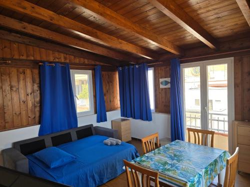 a bedroom with a bed and a table with chairs at Attico vista mare in centro in Gallipoli