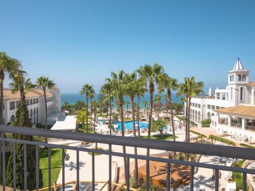a view of a resort with a pool and palm trees at DAIA Slow Beach Hotel Conil - Adults Only Recommended in Conil de la Frontera