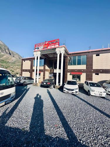 a shadow of a person standing in front of a parking lot at Eagle Resort Hotel and Restaurant in Nārān