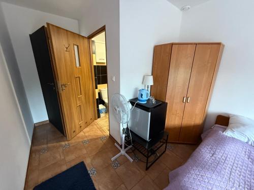 a bedroom with a bed and a dresser and a mirror at VITA Augustów in Augustów