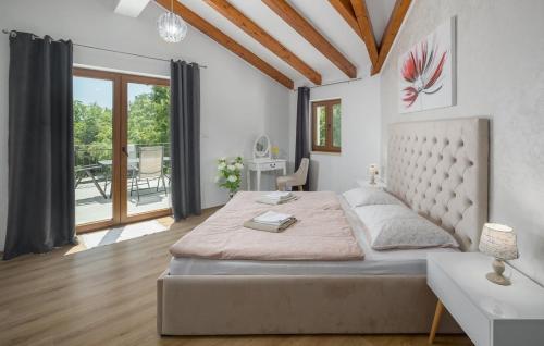 a bedroom with a large bed and a large window at Villa Sole Mio by Villas Guide in Crnibek