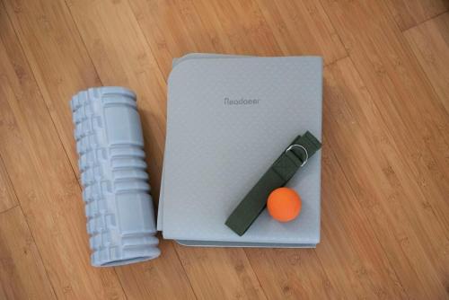 a notebook with a pen and an orange on a table at kotinoma kuu in Hakozaki