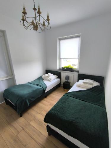 Ένα ή περισσότερα κρεβάτια σε δωμάτιο στο Green Apartament