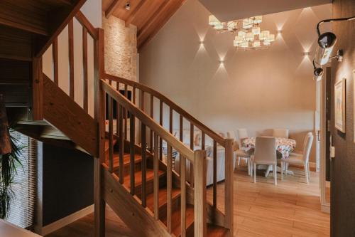 a staircase leading to a dining room with a table at Przystań Spokoju in Chmielno