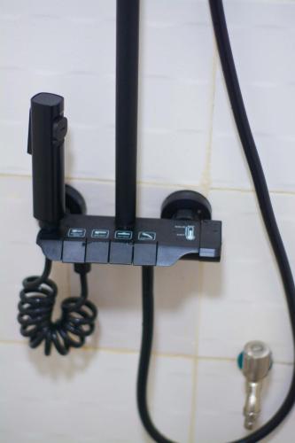 a black corded phone hanging on a wall at Residence The Champion 2 in Ouidah