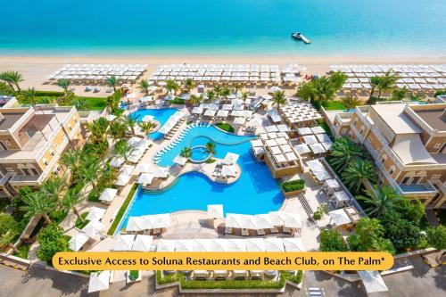 an aerial view of a resort with a swimming pool at The First Collection Dubai Marina in Dubai