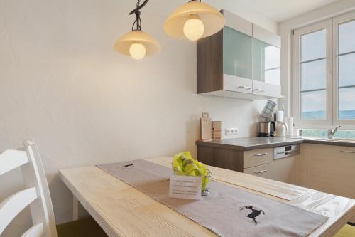 a kitchen with a table with a bowl of fruit on it at Landhaus Christophorus in Forbach