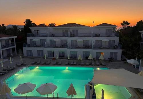 a large swimming pool in front of a building at Happy Village - Latchi in Polis Chrysochous