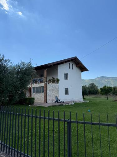 a white house with a fence in front of it at B&B La Coccinella in Amaseno