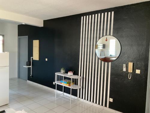 a black and white room with a mirror and a table at L'atelier Monochrome in Montjoly