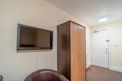 a room with a flat screen tv on a wall at The Grand Scarborough in Scarborough