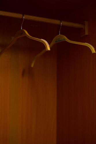 a closet with two hangers on a wooden wall at Residence The Champion 2 in Ouidah