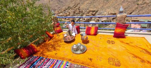 a table with colorful pillows on top at Atlas Pearl in Aguersioual