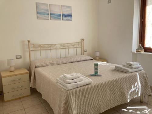 Un dormitorio con una cama con toallas. en Orizzonte Conero holiday home, en Porto Recanati