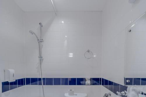 a bathroom with a shower and a tub and a sink at The Grand Scarborough in Scarborough