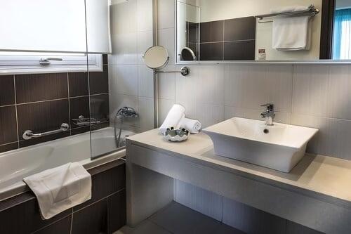 a bathroom with a sink and a mirror at Glaros Beach Hotel in Hersonissos