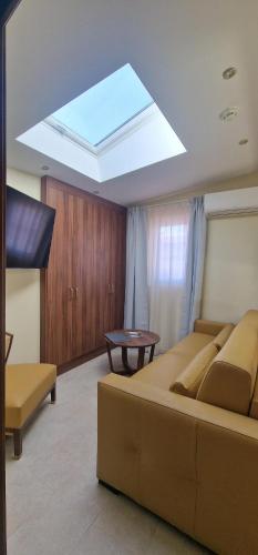 a living room with a couch and a skylight at Résidence Aston la Scala in Nice