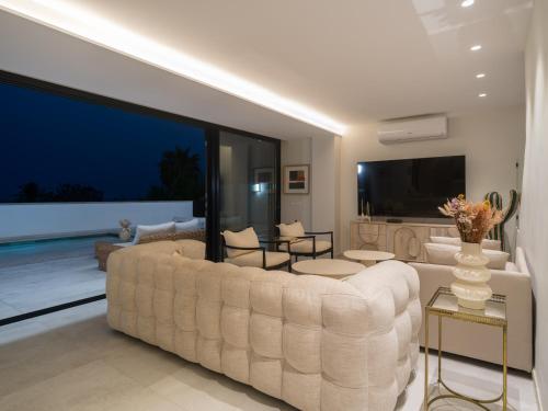 a large living room with a large white couch at Las Burras Ocean Front Views in San Bartolomé