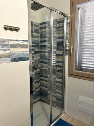 a shower with a glass door in a bathroom at Appartamento Gaia in Santa Maria Navarrese