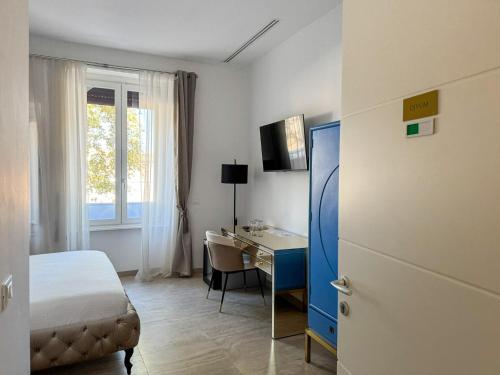 a hotel room with a bed and a desk and a window at Alto Apartment in Rome