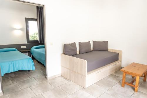 a small bedroom with a bed and a table at RVApartaments Treumal Park in Platja d'Aro