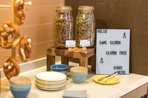 two jars of food on a counter with bowls and pretzels at OKKO Hotels Strasbourg Centre in Strasbourg