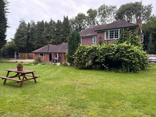 a picnic table in the yard of a house at Da Vinci Guest House & Guest Parking, A Real Gem in Crawley