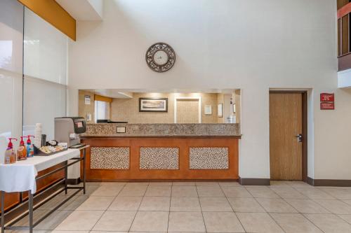 a kitchen with a counter and a clock on the wall at Best Western Manassas in Manassas