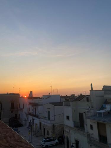 a view of a city at sunset with buildings at CasaLina in Sammichele di Bari