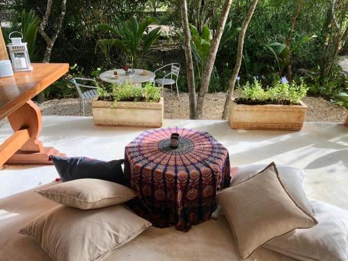 a table and some pillows on a patio at Ki-Ra Holistic Living in Boca de Chavón