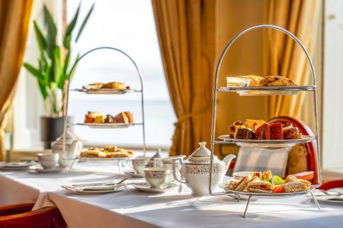 a table with plates of food and pastries on plates at The Grand Scarborough in Scarborough