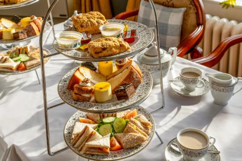 a table topped with plates of pastries and cups of coffee at The Grand Scarborough in Scarborough