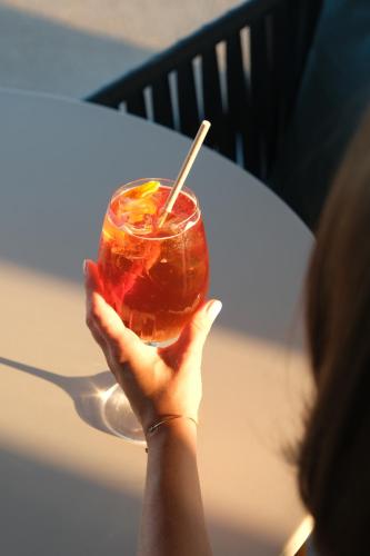 a person holding up a drink with a straw at Santateresa in Bonifacio