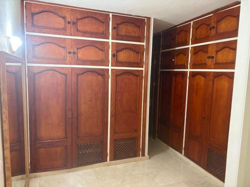 a closet with wooden doors in a room at Vivienda vacacional guanche in San Sebastián de la Gomera