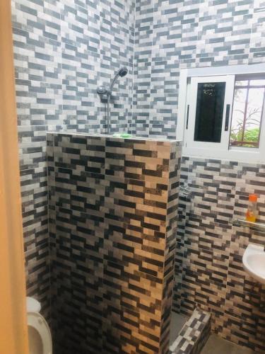 a bathroom with a toilet and a sink at American Studio Angondjé - Secure Parking in Libreville