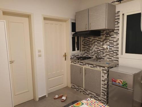 a kitchen with a sink and a stove at American Studio Angondjé - Secure Parking in Libreville