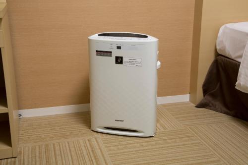 a small appliance sitting on the floor in a room at Shizutetsu Hotel Prezio Shizuoka Ekinan in Shizuoka