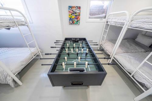 a ping pong table in a room with bunk beds at Mountain View - World Cup in Beaupré