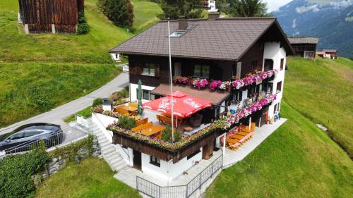 an aerial view of a house with a table and chairs at Alpinchalet Zigjam in Gaschurn