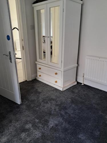 a white cabinet in a room with a carpet at Southfield lodge in Middlesbrough
