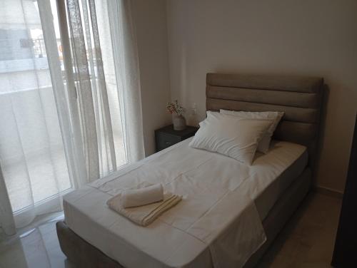a bed with two towels on it in a bedroom at GN summer guest house P in Leptokarya