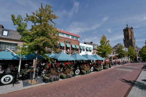 a street with a group of umbrellas and flowers at Het Wapen van Elst in Elst