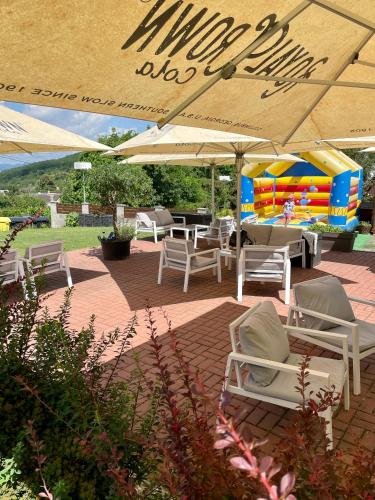 a group of chairs and umbrellas on a patio at Apartmán v Šenku 