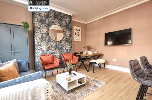 a living room with a couch and a table at Beautiful 3BDR House By Homebird Property Management Short Lets & Serviced Accommodation Leeds With Free Parking & Free WiFi in Leeds