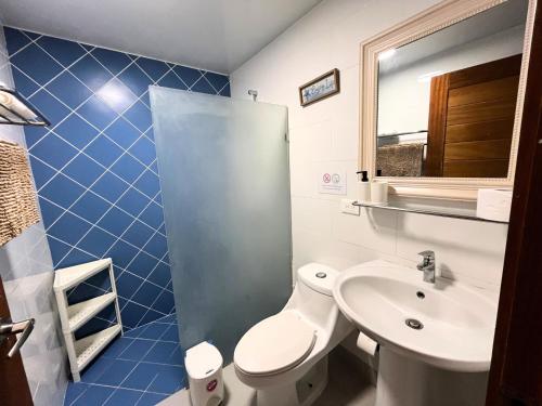 a bathroom with a toilet and a sink at 3 Min Walk to Bibijagua Beach - Spacious 2BR in Punta Cana