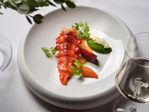 a plate of food with meat and vegetables on a table at Contessina Suites & Spa - Adults Only in Tsilivi